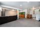 Finished basement with a large aquarium, seating area, laundry area, and utility sink at 10490 W 78Th Ave, Arvada, CO 80005