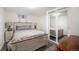 Bedroom features neutral decor, carpet, closet, and large bed with side tables at 10490 W 78Th Ave, Arvada, CO 80005
