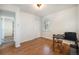Simple bedroom with hardwood floors, a closet, and a window providing natural light at 10490 W 78Th Ave, Arvada, CO 80005