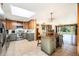 Open kitchen featuring a center island, stainless appliances, and a seamless flow to the dining area at 10490 W 78Th Ave, Arvada, CO 80005
