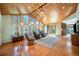Bright living room features vaulted wood ceilings, hardwood floors and large windows overlooking the front yard at 10490 W 78Th Ave, Arvada, CO 80005