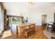 Open-concept dining area featuring hardwood floors and large windows with views of the front yard at 10490 W 78Th Ave, Arvada, CO 80005