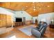 Spacious living room with vaulted wood ceilings, hardwood floors, a ceiling fan and a large entertainment center at 10490 W 78Th Ave, Arvada, CO 80005