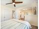 Bedroom featuring neutral walls and carpet, a ceiling fan, and partial wall overlooking a living area at 10490 W 78Th Ave, Arvada, CO 80005