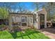 Exterior of rustic outbuilding with screen doors, stone base, and adjacent garden bed at 10490 W 78Th Ave, Arvada, CO 80005