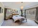 Serene bedroom featuring large windows, neutral color palette, decorative chandelier, and ample natural light at 3346 Red Tree Pl, Castle Rock, CO 80104