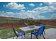 Backyard featuring a patio set, lawn, and landscaping with a view of a hill and blue skies at 1031 Turnberry Cir, Louisville, CO 80027
