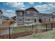Inviting backyard featuring a well-manicured lawn, a fenced perimeter, and a charming outdoor seating area on a concrete patio at 1031 Turnberry Cir, Louisville, CO 80027