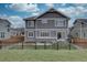 Beautifully fenced backyard includes a patio and manicured lawn offering privacy and space for outdoor relaxation at 1031 Turnberry Cir, Louisville, CO 80027