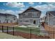 Picture-perfect backyard with a black metal fence, patio dining set, and lush lawn, ideal for serene outdoor living at 1031 Turnberry Cir, Louisville, CO 80027