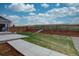 Backyard featuring a concrete patio, grass, and landscaped area with fencing, enhancing privacy and outdoor appeal at 1031 Turnberry Cir, Louisville, CO 80027
