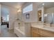 Bright bathroom features a double vanity, soaking tub with decorative tile, and an open doorway to the bedroom at 1031 Turnberry Cir, Louisville, CO 80027