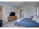 Bright bedroom features vaulted ceiling, neutral walls and carpet, and access to the bathroom at 1031 Turnberry Cir, Louisville, CO 80027