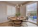 Bright dining area features a stylish light fixture and access to the patio for seamless indoor-outdoor living at 1031 Turnberry Cir, Louisville, CO 80027