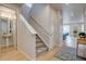 Bright entryway with hardwood floors, a staircase, and a view into the dining area at 1031 Turnberry Cir, Louisville, CO 80027