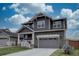 Charming two-story home with a gray exterior, covered porch, and attached two-car garage at 1031 Turnberry Cir, Louisville, CO 80027