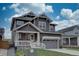 Beautiful two-story home featuring stone accents, a welcoming porch, and well-maintained landscaping at 1031 Turnberry Cir, Louisville, CO 80027