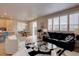 Bright living area with a large sofa and access to the dining area and kitchen providing an open concept layout at 1031 Turnberry Cir, Louisville, CO 80027