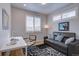 Cozy home office with a modern desk, comfortable sofa, and bright windows for a productive workspace at 1031 Turnberry Cir, Louisville, CO 80027