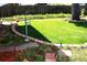 Manicured backyard featuring a lush green lawn, garden beds, and mature tree for shade at 11823 Williams Way, Northglenn, CO 80233