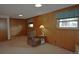 Basement with paneling, a chair, and a covered window with a small table at 11823 Williams Way, Northglenn, CO 80233