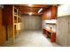 Unfinished basement featuring exposed beams, concrete walls, and built-in shelving at 11823 Williams Way, Northglenn, CO 80233