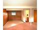Unfinished basement area featuring concrete flooring, wood paneling, and a window at 11823 Williams Way, Northglenn, CO 80233