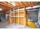 Unfinished basement with overhead beams, storage shelves, and concrete walls are features of this useful space at 11823 Williams Way, Northglenn, CO 80233