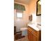 Bathroom featuring a window, a mirror, and a sink with storage cabinet at 11823 Williams Way, Northglenn, CO 80233