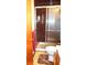 Bathroom featuring a tiled shower stall with glass doors and toilet at 11823 Williams Way, Northglenn, CO 80233