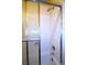 Bathroom featuring a white tiled shower with glass door at 11823 Williams Way, Northglenn, CO 80233