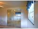 Bedroom features mirrored closet doors and a window with blue curtains at 11823 Williams Way, Northglenn, CO 80233