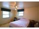Bedroom with two windows, curtains, and a bed with a pink comforter at 11823 Williams Way, Northglenn, CO 80233