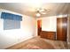 Bedroom with ceiling fan, a wooden dresser and window with blue curtains at 11823 Williams Way, Northglenn, CO 80233