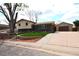 Charming two-story home with brick accents, a well-maintained lawn, and a detached garage with long driveway at 11823 Williams Way, Northglenn, CO 80233
