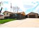 Charming home with a well-maintained lawn, a detached garage, and an American flag waving in the yard at 11823 Williams Way, Northglenn, CO 80233