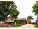 Charming split-level home with brick accents, mature trees, and a spacious front yard at 11823 Williams Way, Northglenn, CO 80233