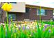 Charming two-story brick home featuring a well-maintained front yard with colorful flowers at 11823 Williams Way, Northglenn, CO 80233
