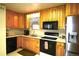 Well-equipped kitchen with wooden cabinets, modern appliances, and ample counter space at 11823 Williams Way, Northglenn, CO 80233