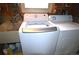 Laundry room with a front-load washing machine and dryer next to a sink at 11823 Williams Way, Northglenn, CO 80233