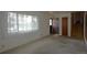 Bright and airy living room featuring neutral carpet, a large window, and access to the entryway and staircase at 11823 Williams Way, Northglenn, CO 80233