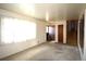 Bright living room with large window and neutral carpet, ready for personal touches and decor at 11823 Williams Way, Northglenn, CO 80233