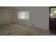 Bright living room featuring large windows and neutral carpeting at 11823 Williams Way, Northglenn, CO 80233