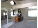 Bright living room with ceiling fan, two mirrors and tv on a media cabinet; neutral carpet throughout at 11823 Williams Way, Northglenn, CO 80233