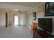 Open living room featuring neutral carpeting and a sliding glass door at 11823 Williams Way, Northglenn, CO 80233