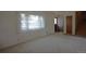 Inviting living room featuring carpet floors, large window, staircase and front door at 11823 Williams Way, Northglenn, CO 80233