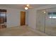 Spacious main bedroom featuring an ensuite bath, mirrored closet doors, and neutral carpeting at 11823 Williams Way, Northglenn, CO 80233
