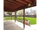 Covered patio overlooking a well-manicured backyard with lush landscaping and a flower bed at 11823 Williams Way, Northglenn, CO 80233