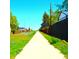 Scenic walking path with lush green grass and houses on both sides, perfect for a leisurely stroll at 11823 Williams Way, Northglenn, CO 80233