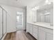 Modern bathroom with double sinks, quartz countertops, and glass-enclosed shower at 18971 E 96Th Pl, Commerce City, CO 80022